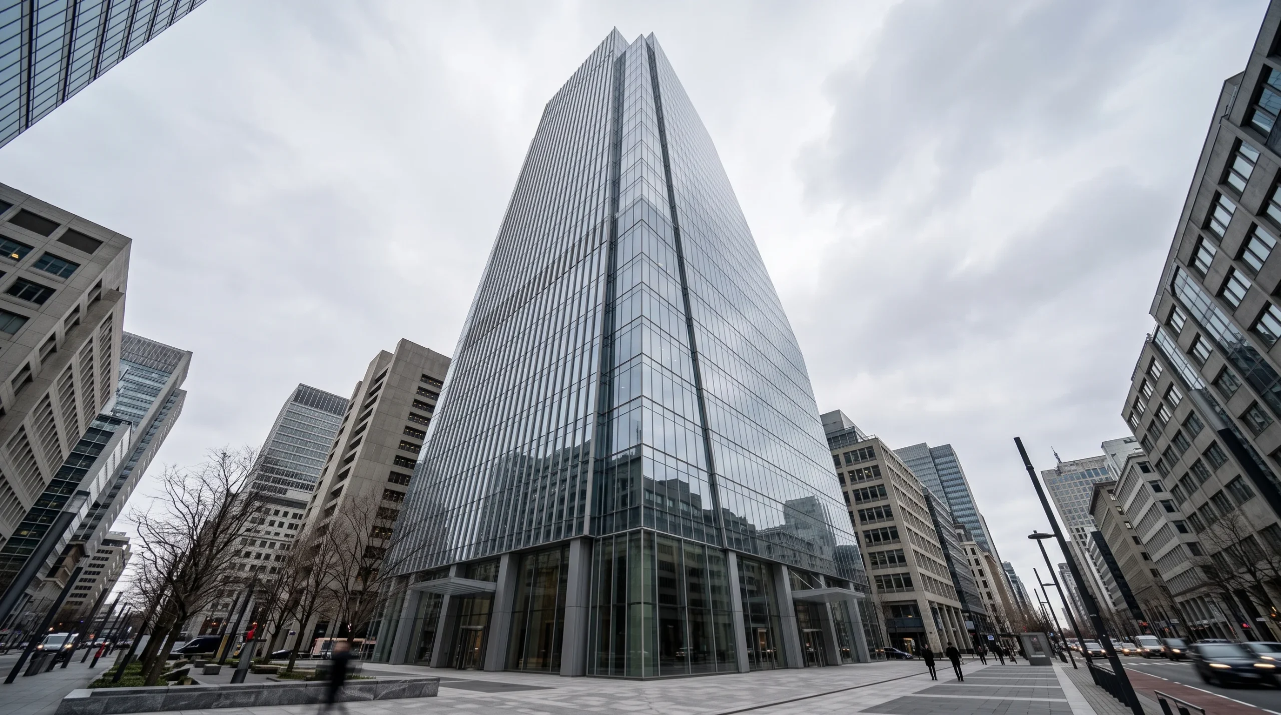 A modern glass office building representing large-scale corporate operations.